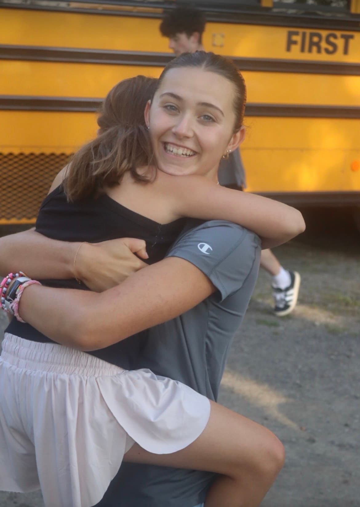 Susie McNamee sharing a hug with a friend at camp