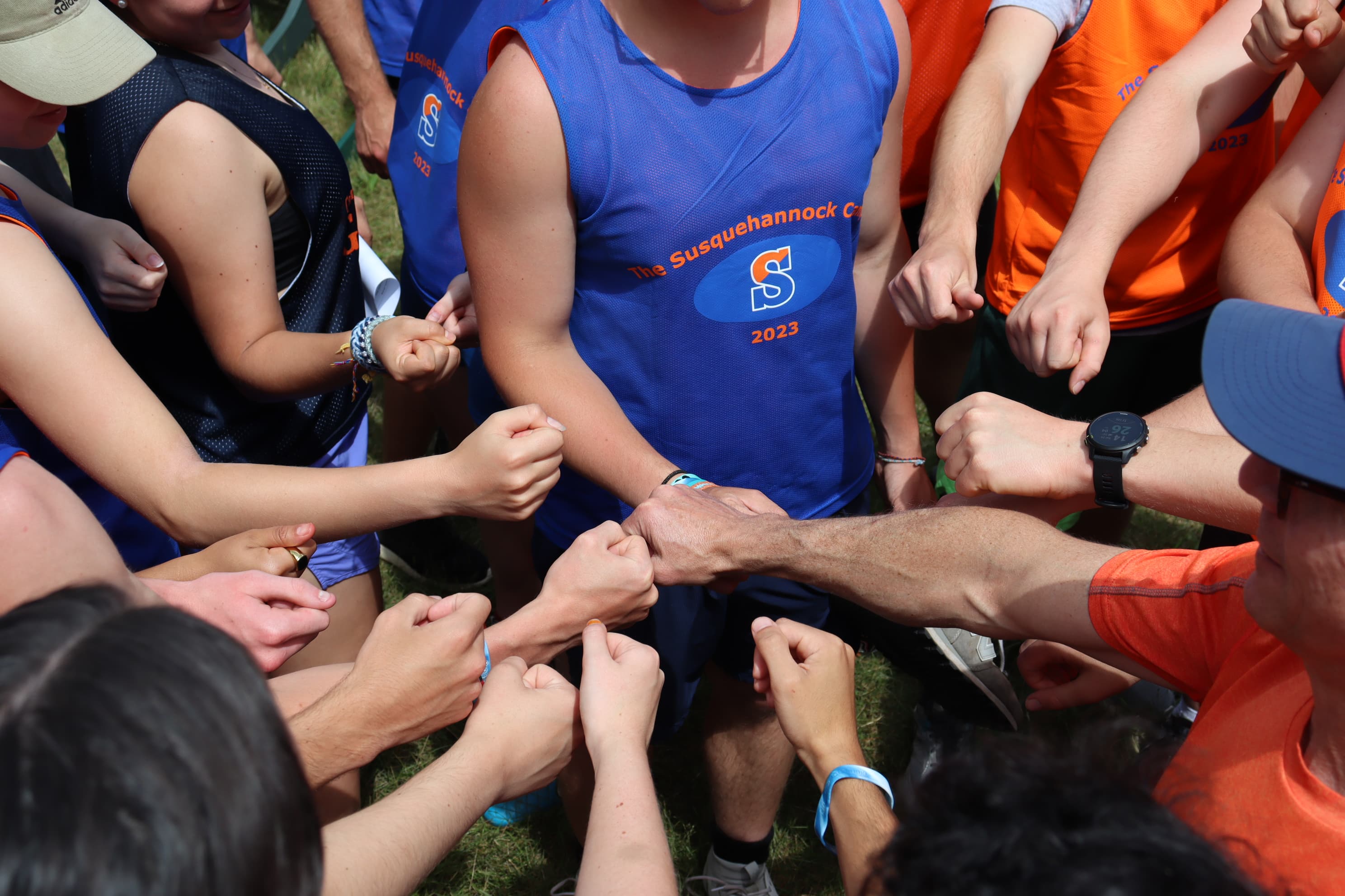 Campers showing teamwork with hands together in the middle